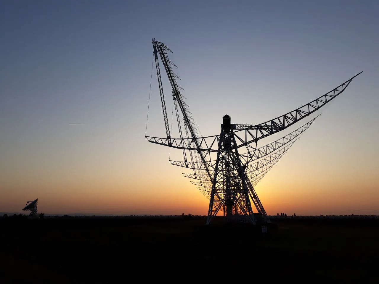 Radio telescope structure at sunset