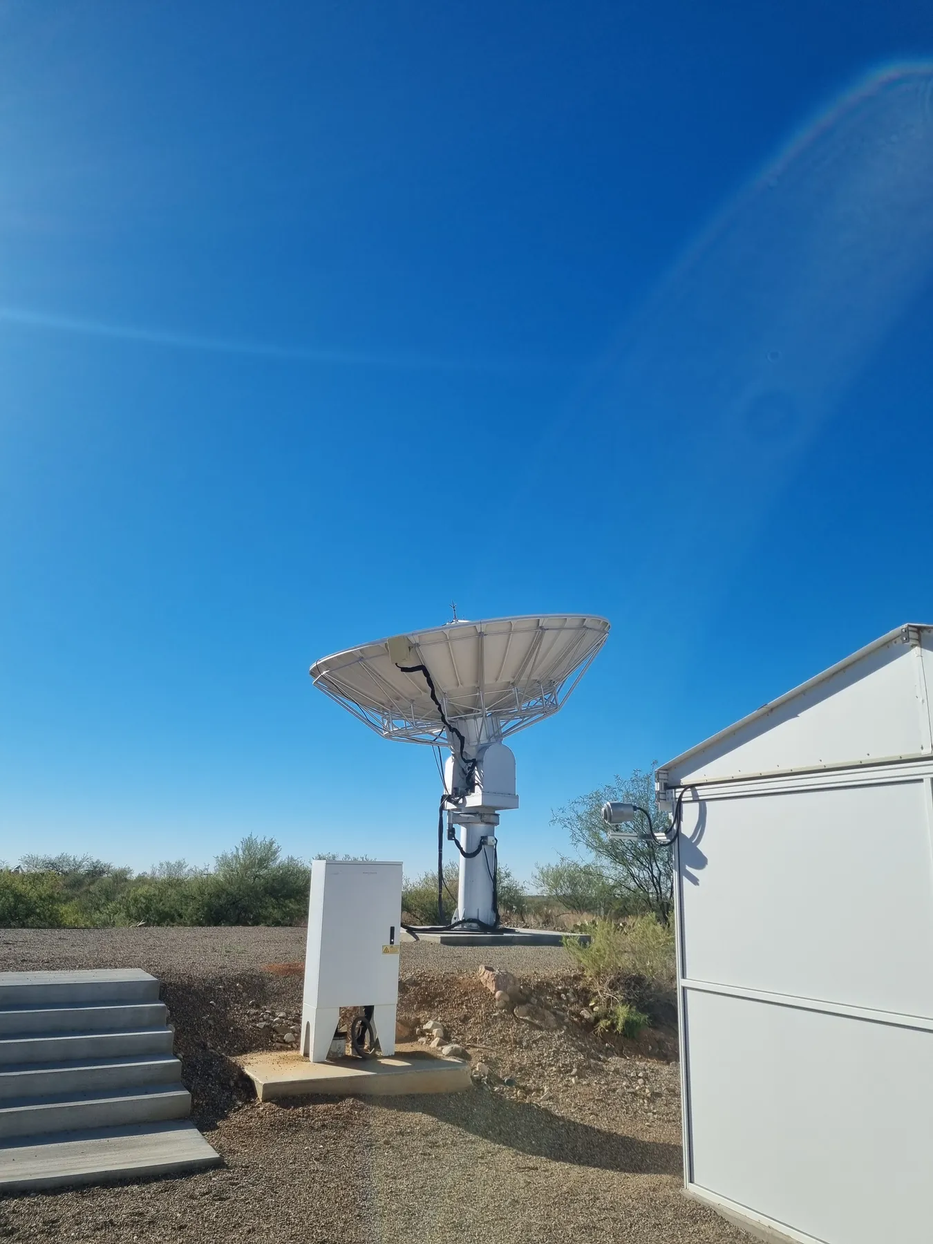 Small radio dish in a desert setting