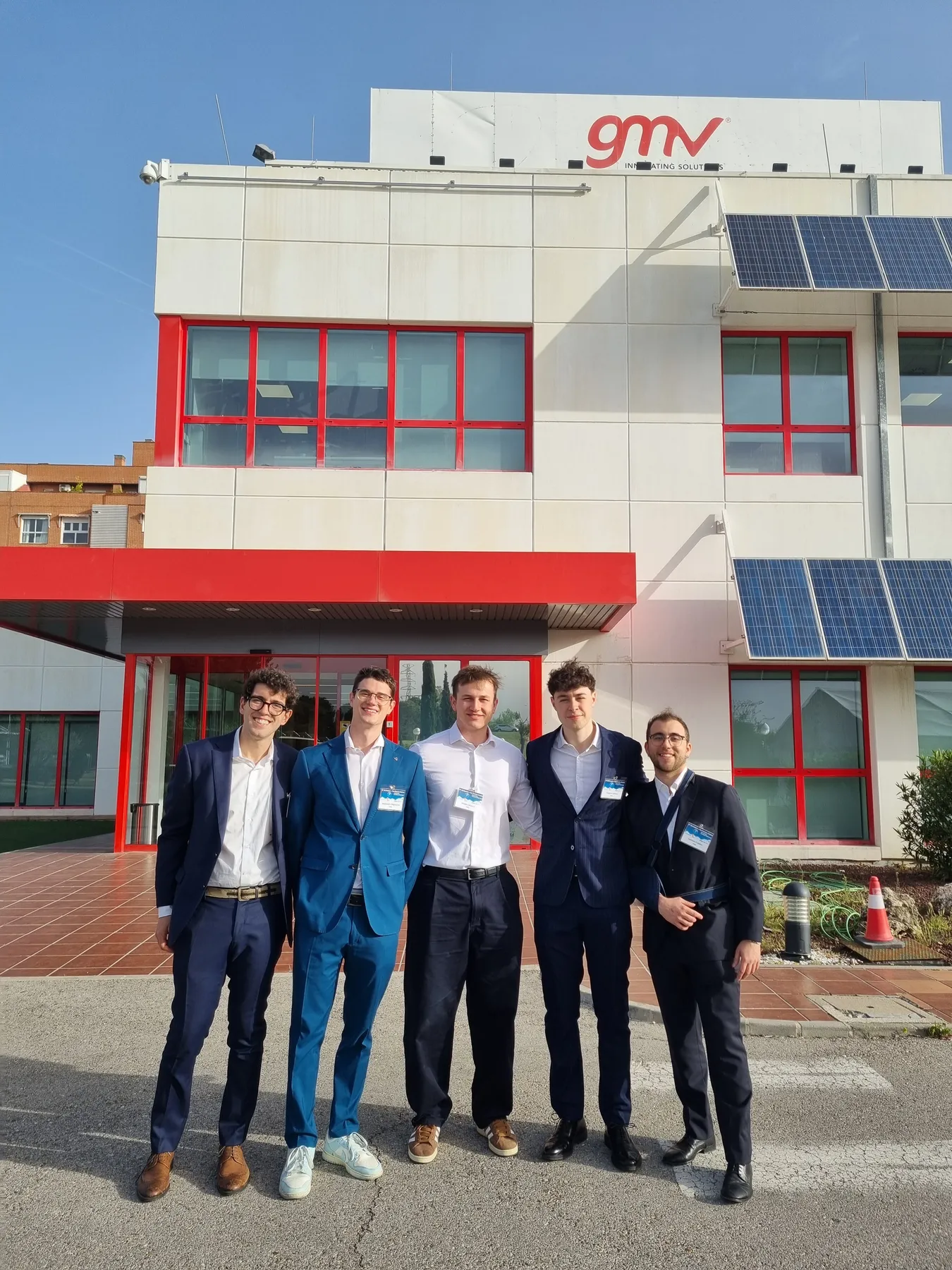 Group standing outside a GMV building