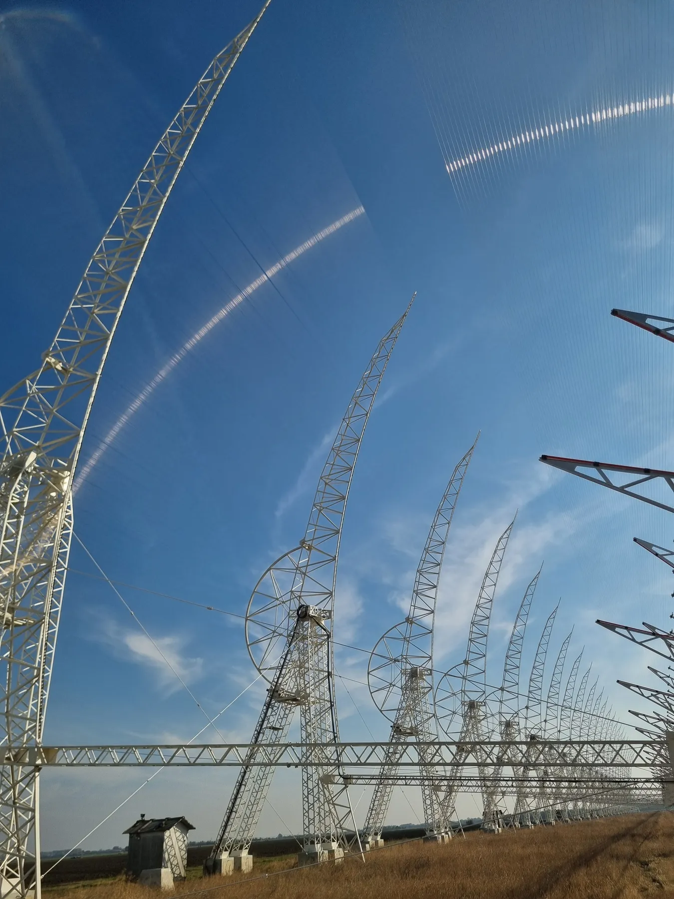 Array of radio telescope structures under a blue sky