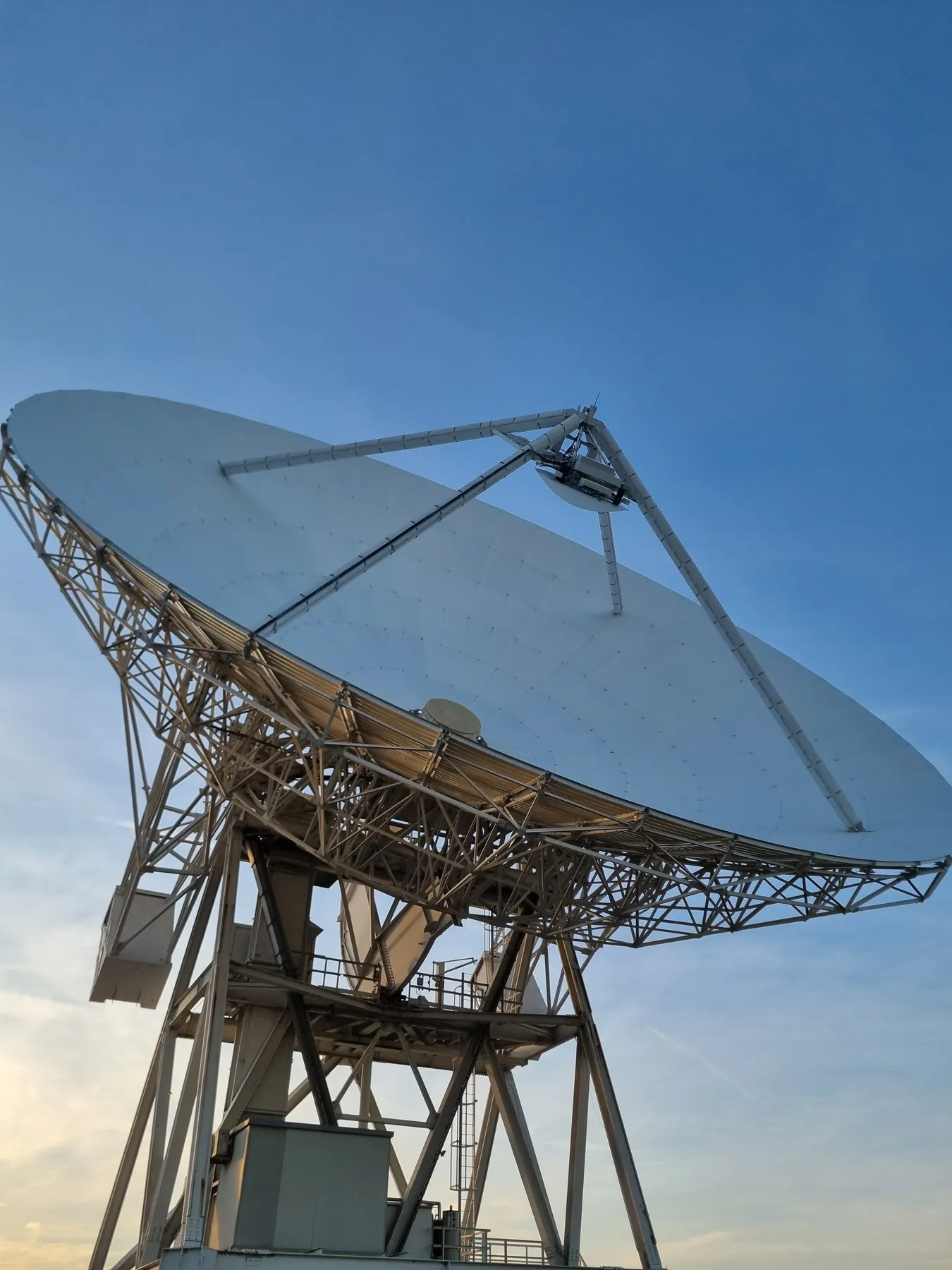 Close view of a radio telescope against the sky