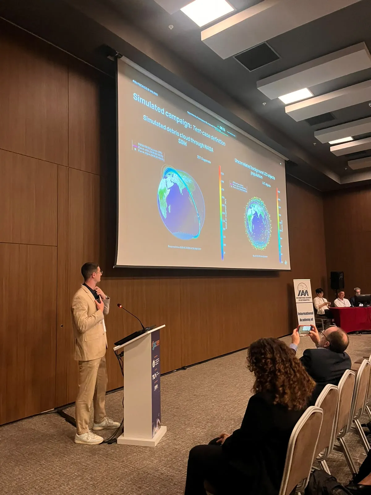 Speaker presenting scientific slides to an audience
